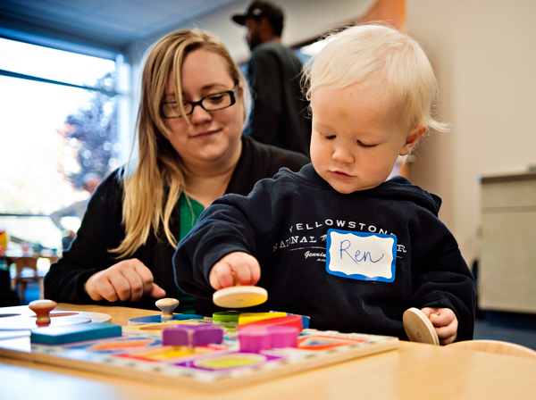 Colleen Lucas, left, and Ren play with shape puzzles at Great Start.