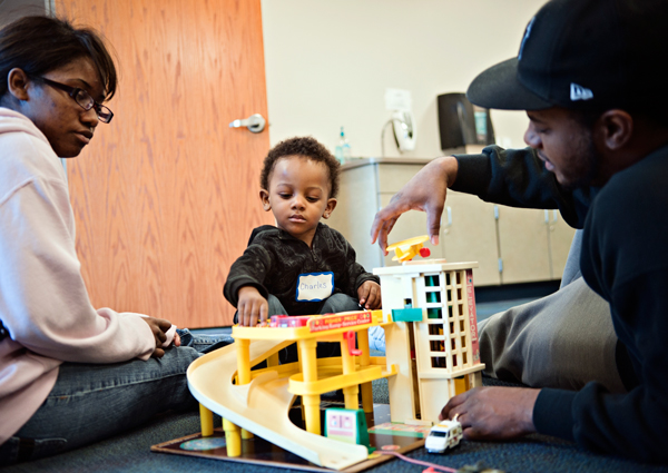 Ricquya, left, and Charles Wilbon play with their son Charles at Great Start.