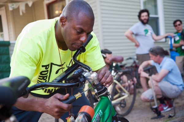 Edison neighborhood's Steve Bostic puts the finishing touches on his bike at the Open Roads Fixapalooza.